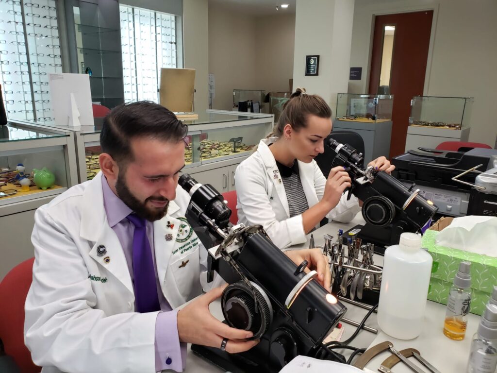 A man and a woman using microscope